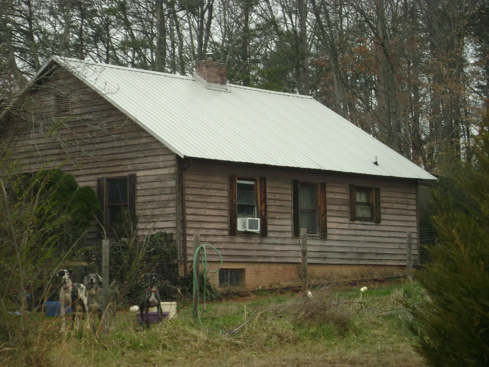 White metal roof on an old wood sided farmhouse, from a Asphalt Shingle Roof Repair job in Ooltewah